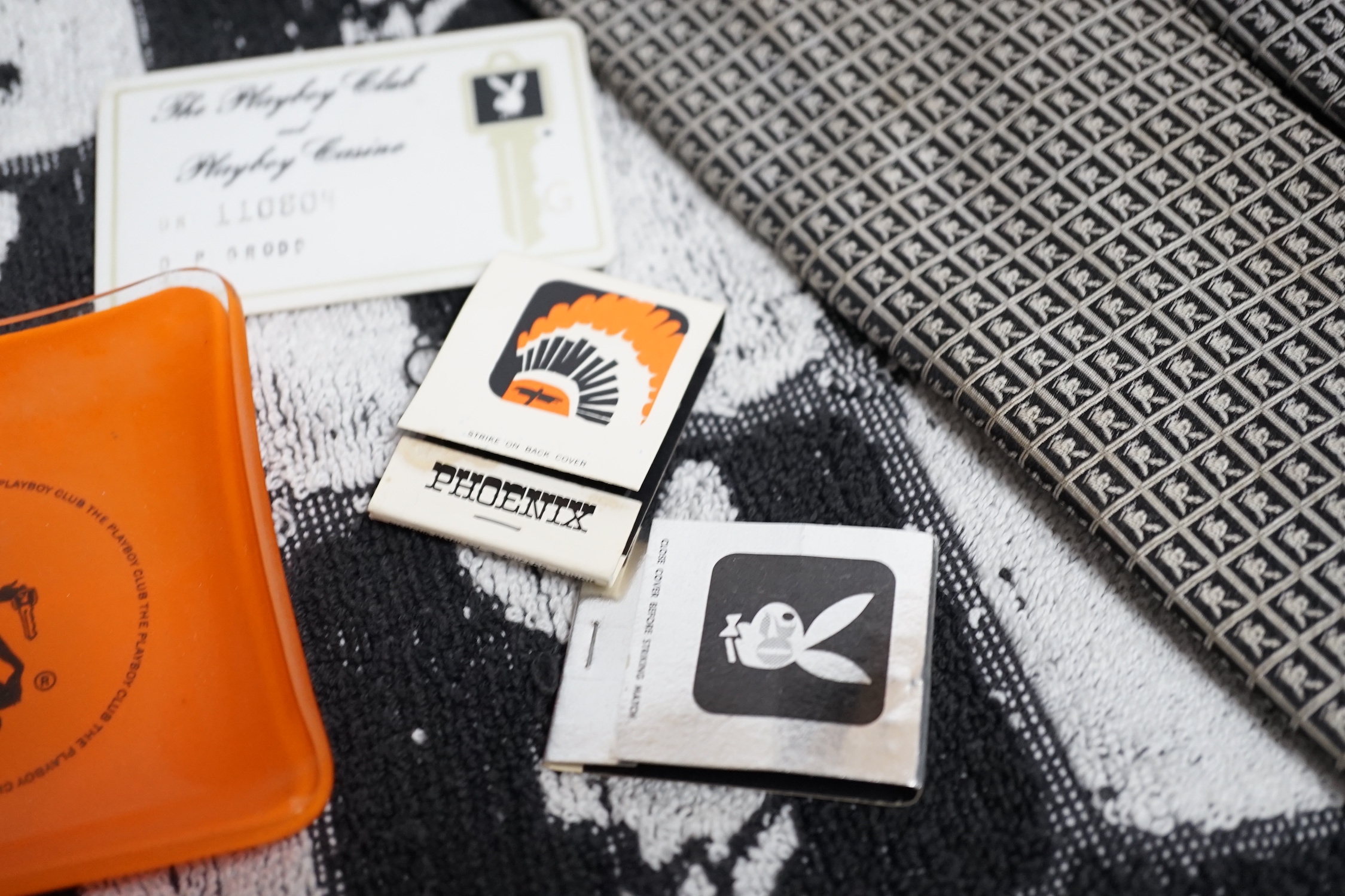 Playboy memorabilia: tie, an ashtray, two packs of matches, towel, a pair of cuff-links, membership card